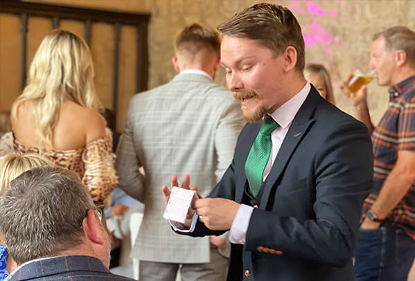 Magician Ryan Beck performing at a wedding